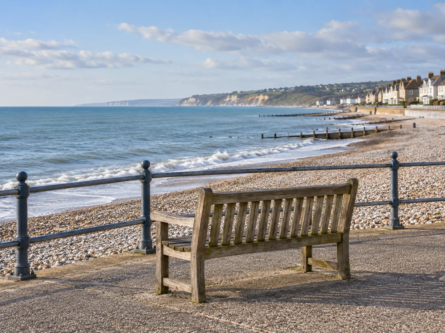 Illustration of a quiet British seaside promenade and a bench overlooking the beach